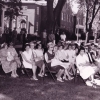 <p>A group watching a ceremony from in front of Building 10 on Officers&#39; Row, view north, July 1964.</p>